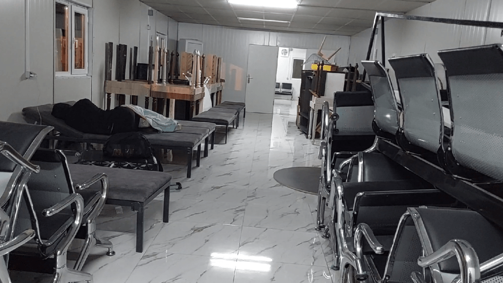 The waiting hall at Alat Port with seats and a few loungers